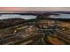 Expansive aerial view showcasing a lake, golf course, community pool, and tennis courts at 17300 Pesce Loop, Montverde, FL 34756