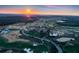 Majestic aerial view with a vibrant sunset, community pool, golf course, and residential properties at 17300 Pesce Loop, Montverde, FL 34756