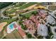 Stunning aerial view featuring a pool, golf course and unique architecture with terracotta roofs at 17300 Pesce Loop, Montverde, FL 34756