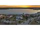 Luxury home with stunning lake views, lush landscaping, and a prime waterfront location at sunset at 17300 Pesce Loop, Montverde, FL 34756