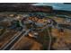 Gorgeous aerial view with a serene lake backdrop, community pool, and tennis courts at 17300 Pesce Loop, Montverde, FL 34756