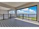 Balcony featuring black metal railings and expansive views of the water and backyard at 17300 Pesce Loop, Montverde, FL 34756