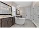 Elegant bathroom featuring double vanities, freestanding tub, and glass-enclosed shower at 17300 Pesce Loop, Montverde, FL 34756