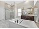 Bathroom featuring double vanity, soaking tub and glass enclosed shower at 17300 Pesce Loop, Montverde, FL 34756