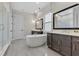 Elegant bathroom featuring double vanities, freestanding tub, and glass-enclosed shower at 17300 Pesce Loop, Montverde, FL 34756