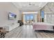 This bedroom offers outdoor access, statement wall, a TV and tray ceiling at 17300 Pesce Loop, Montverde, FL 34756