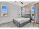 Bedroom with a decorative accent wall and light-filled windows at 17300 Pesce Loop, Montverde, FL 34756