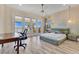 Bedroom includes a desk, and access to the balcony overlooking the water at 17300 Pesce Loop, Montverde, FL 34756