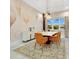 Stylish dining room with modern furniture, an elegant chandelier, and decorative wallpaper at 17300 Pesce Loop, Montverde, FL 34756