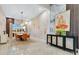 Bright dining room with orange chairs, a decorative wall and modern chandelier at 17300 Pesce Loop, Montverde, FL 34756