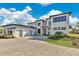 Modern home featuring a spacious driveway and a manicured front yard at 17300 Pesce Loop, Montverde, FL 34756
