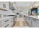 Modern kitchen with stainless steel appliances, white cabinets, and a spacious island with elegant light fixtures at 17300 Pesce Loop, Montverde, FL 34756