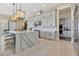 Modern kitchen featuring a large island, pendant lighting, and stainless steel appliances at 17300 Pesce Loop, Montverde, FL 34756