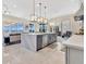 Open-concept kitchen with a large island, modern appliances, and view of the living room and pool area at 17300 Pesce Loop, Montverde, FL 34756