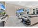 Inviting living room featuring a large sectional sofa, a sleek entertainment center, and large sliding glass doors at 17300 Pesce Loop, Montverde, FL 34756