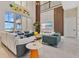 Spacious living room with modern furniture, large windows with water views, and a decorative wall at 17300 Pesce Loop, Montverde, FL 34756