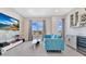 Cozy living room with blue couch, a TV and windows with views at 17300 Pesce Loop, Montverde, FL 34756