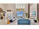 Open living area featuring modern sofas, high ceilings, and large windows providing abundant natural light and scenic views at 17300 Pesce Loop, Montverde, FL 34756