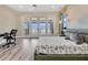 Bright main bedroom with water views, desk, and balcony access through sliding doors at 17300 Pesce Loop, Montverde, FL 34756