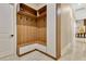 A mudroom with custom shelving and a bench for storage at 17300 Pesce Loop, Montverde, FL 34756