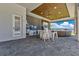 Inviting outdoor kitchen with a bar area perfect for entertaining by the pool and waterfront at 17300 Pesce Loop, Montverde, FL 34756