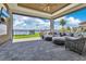 Luxurious outdoor living area with comfortable seating and gorgeous waterfront views at 17300 Pesce Loop, Montverde, FL 34756