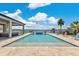 Backyard featuring an inviting pool, stylish patio furniture, and scenic lake view at 17300 Pesce Loop, Montverde, FL 34756