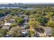 Expansive aerial view showcasing a lush, green neighborhood with a lake and city skyline in the background at 2107 University Dr, Orlando, FL 32804