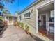 Backyard featuring a deck that opens to an interior space, with a quaint porch and potted plants at 2107 University Dr, Orlando, FL 32804