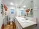 Bright bathroom boasting double sinks, a large mirror, and decorative shower curtain at 2107 University Dr, Orlando, FL 32804