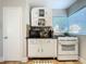 Vintage-style kitchen with white cabinetry, a built in china cabinet, and plenty of counter space for cooking and storage at 2107 University Dr, Orlando, FL 32804