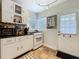 A vintage-style kitchen with tiled floors and bright lighting, ideal for cooking and entertaining guests at 2107 University Dr, Orlando, FL 32804