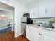 Efficient kitchenette with stainless steel refrigerator, microwave, and white cabinets with granite countertops at 2107 University Dr, Orlando, FL 32804