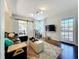 Bright living room with hardwood floors, a comfortable sectional, and a sliding barn door for an open feel at 2107 University Dr, Orlando, FL 32804