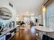 Open-concept living area with hardwood floors and a comfortable seating arrangement with ample natural light and view to the kitchen at 2107 University Dr, Orlando, FL 32804