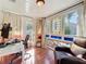 Home office features hardwood floors, ample natural light from decorative windows, and comfortable seating at 2107 University Dr, Orlando, FL 32804