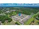 Aerial view of a community surrounded by lush green trees and featuring a central pond at 2313 Ivy Harvest Pl, Oviedo, FL 32765