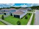 This home has a well maintained backyard with green grass, screened porch, and neatly trimmed shrubs at 2313 Ivy Harvest Pl, Oviedo, FL 32765