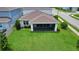 Aerial view of a spacious backyard with lush green grass and a screened-in porch at 2313 Ivy Harvest Pl, Oviedo, FL 32765