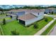 Aerial view of a backyard with lush green grass, enclosed by a white fence and showcasing a screened-in porch at 2313 Ivy Harvest Pl, Oviedo, FL 32765