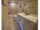 The bathroom features a bathtub, tile surround, and modern vanity with matte black fixtures at 2313 Ivy Harvest Pl, Oviedo, FL 32765