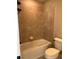 Tiled tub-shower combination with a white toilet at 2313 Ivy Harvest Pl, Oviedo, FL 32765