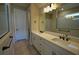 Bathroom with double vanity, white cabinets, and walk-in shower at 2313 Ivy Harvest Pl, Oviedo, FL 32765