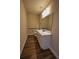 Powder room featuring modern vanity, rectangular mirror, and wood-look tile flooring at 2313 Ivy Harvest Pl, Oviedo, FL 32765