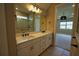 Bathroom with dual sinks, white cabinets, tile flooring, and large mirror at 2313 Ivy Harvest Pl, Oviedo, FL 32765