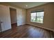 Bright bedroom featuring wood floors, neutral walls, and a window letting in natural light at 2313 Ivy Harvest Pl, Oviedo, FL 32765