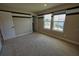 Comfortable bedroom featuring neutral carpet, two windows, and freshly painted walls at 2313 Ivy Harvest Pl, Oviedo, FL 32765