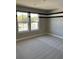 Bright bedroom with neutral carpet and street views from windows at 2313 Ivy Harvest Pl, Oviedo, FL 32765