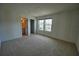 Cozy bedroom featuring neutral carpet, en suite bathroom, and a window with outside views at 2313 Ivy Harvest Pl, Oviedo, FL 32765