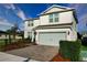 Well-maintained two-story home with a brick driveway, two-car garage, and neatly trimmed bushes at 2313 Ivy Harvest Pl, Oviedo, FL 32765